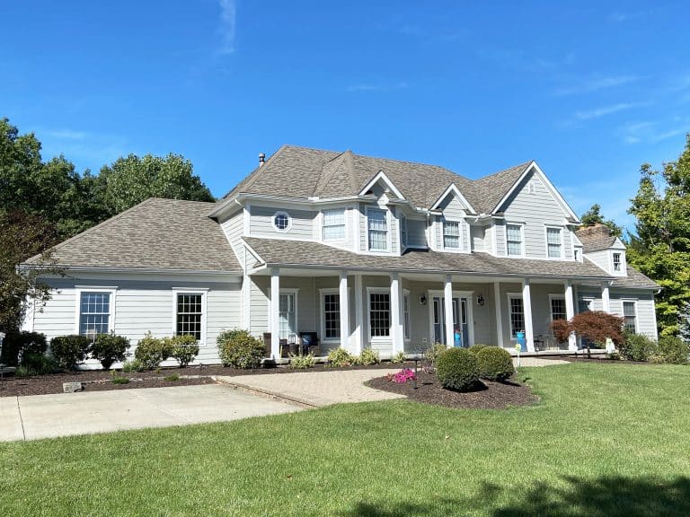 Beautiful home showcasing exterior home remodeling in Medina OH by Medina Exteriors & Remodeling, featuring new roofing, windows, and vinyl siding.