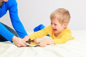 computer addiction, parent taking out touch pad from child